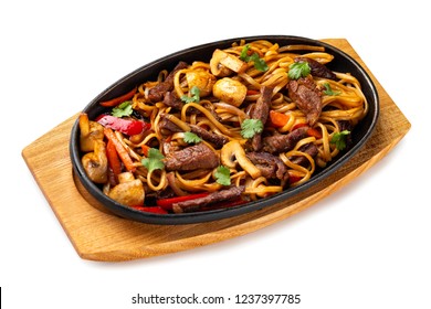 Traditional Chinese Food - Pan Of Udon Noodles With Beef And Vegetables At Wooden Board Isolated At White Background.