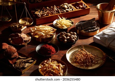 Traditional chinese herbal medicine. Ancient Chinese medicine and herbs on wooden table