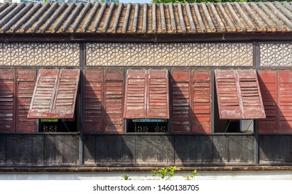 Traditional Chinese House With Awning Windows. Exterior Decoration Of Old Building In Macau, China.