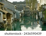 Traditional Chinese houses by a green river in Wuzhen, Zhejiang, China
