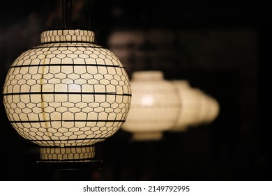 Traditional Chinese Lanterns In A Row In Dark Night. Asian Lanterns In Diminishing Perspective With Black Background