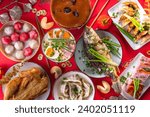 Traditional Chinese lunar New Year dinner table, party invitation, menu background with pork, fried fish, chicken, rice balls, dumplings, fortune cookie, nian gao cake, noodles, chinese decorations