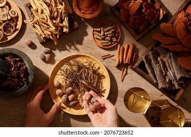 Traditional chinese medicine with herb and spices in brown wooden background mortar and pestile , for medicine advertising , photography traditional medicine content
