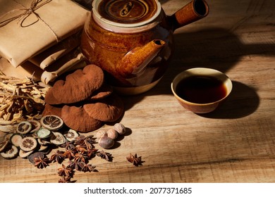 Traditional Chinese Medicine With Herb And Spices In Brown Wooden Background And Traditional Kettle With Medicine Bowl , For Medicine Advertising , Photography Traditional Medicine Content