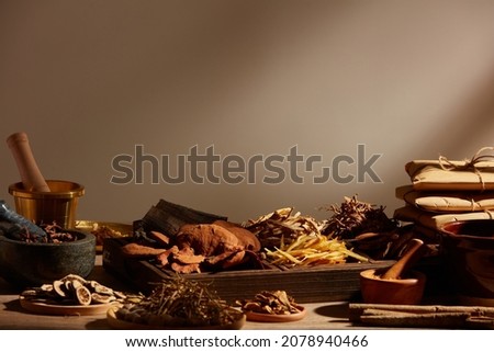 Traditional chinese medicine with herb and spices in light a grey background , for medicine advertising , photography traditional medicine content