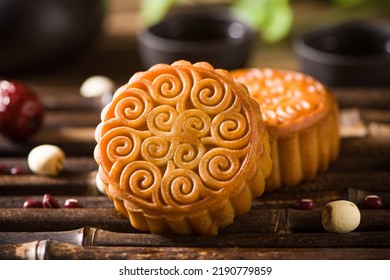 Traditional Chinese mid autumn festival mooncake on wooden table - Shutterstock ID 2190779859