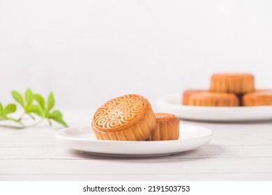 Traditional Chinese mid autumn festival mooncake on white wooden table - Shutterstock ID 2191503753