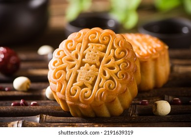 Traditional Chinese mid autumn festival mooncake on wooden table.(the word 