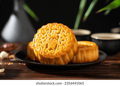 Traditional Chinese mid autumn festival food moon cake on wooden table.(the word 