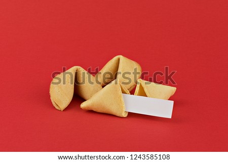Traditional  Chinese new year fortune cookies on red background with white paper for text
