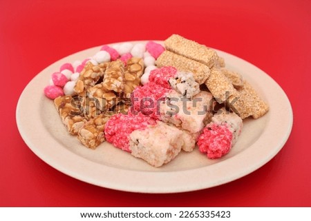 Traditional Chinese sweetmeat made of many ingredients (called Kanom Chan ap in Thai) for offer Sacrifices to god in Chinese culture on red background.