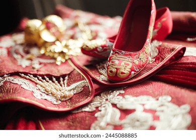 Traditional Chinese wedding attire and embroidered shoes displayed - Powered by Shutterstock