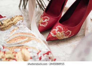 Traditional Chinese wedding attire and embroidered shoes displayed - Powered by Shutterstock