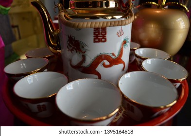 Traditional Chinese wedding tea ceremony tea set, red white and gold teacups, dragon teapot on a red tray, vintage Chinese tea set