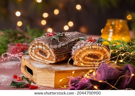 Traditional Christmas cake, chocolate Yule log with festive decorations 