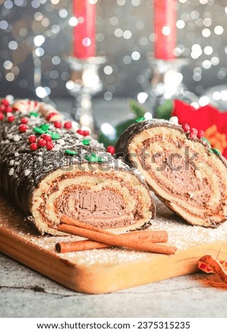 Traditional Christmas cake. Chocolate yule log with christmas decoration on a wooden board. Christmas dessert concept
