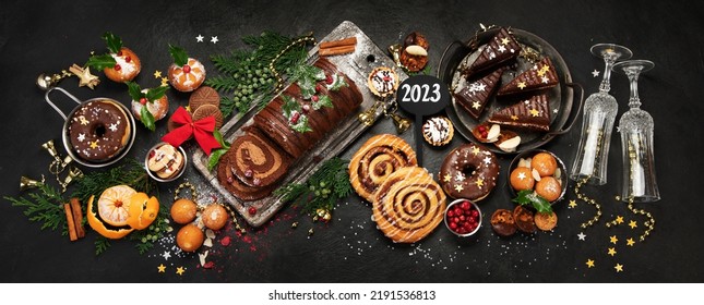 Traditional Christmas dessert on dark background. Holiday food. Top view, panorama - Shutterstock ID 2191536813
