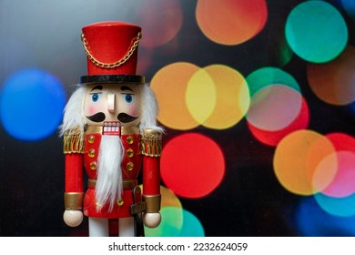 Traditional Christmas doll from Germany, Wooden Nutcracker, with defocused lights in the background