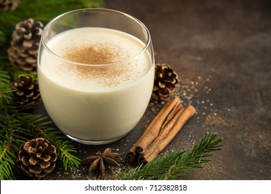 Traditional Christmas drink eggnog with grated nutmeg  and cinnamon. Selective focus.