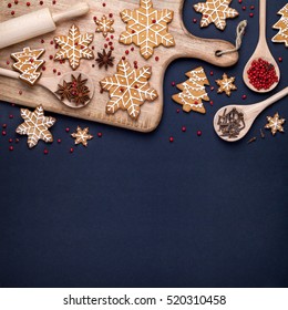 Traditional Christmas Homemade Gingerbread Cookies, Spices And Cutting Board On Dark Blue Background. Holiday, Celebration And Cooking Concept. New Year And Christmas Postcard. Flat Lay, Top View