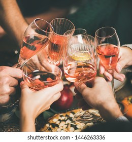 Traditional Christmas Or New Year Holiday Celebration Party. Friends Or Family Feasting And Clinking Glasses With Rose Wine At Festive Christmas Table With Homemade Snacks, Square Crop