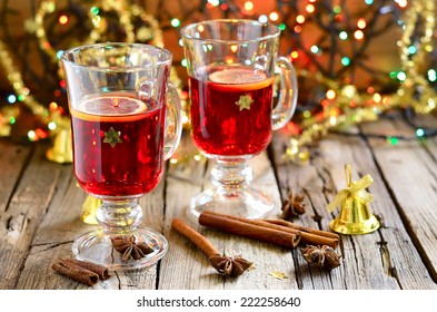 Traditional Christmas punch with spices such as cinnamon and star anise in a glass cups decorated with golden stars - Powered by Shutterstock