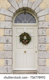 Traditional Christmas Wreath On An English Country House Door. Suitable For A Christmas Card Or Magazine Cover.