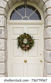 Traditional Christmas Wreath On An English Country House Door. Suitable For A Christmas Card Or Magazine Cover.