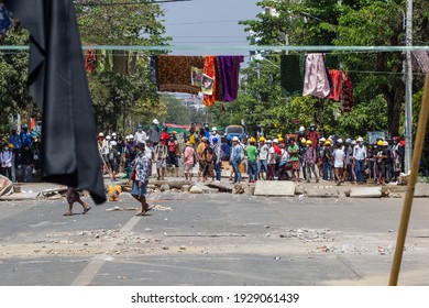 Traditional Clothes Hang On A Rope As Protesters Stand Behind The Clothesline During Against The Military Coup In Yangon, Myanmar On 4 March 2021.