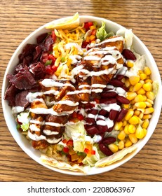 Traditional Cobb Salad Includes Grilled Chicken Dressed With Ranch And BBQ Sauce, Yellow Corn, Cheddar Cheese, Pastrami, Red And Green Pepper And Lettuce. 