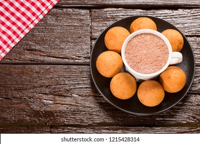 Traditional Colombian Buñuelo - Deep Fried Cheese Bread. Wood Table