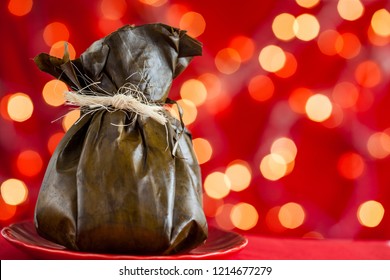 Traditional Colombian Tamale As Made On Tolima Region Over A Christmas Red Background