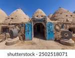 Traditional conical houses of Harran, Sanliurfa, Turkey. Traditional mud brick buildings topped with domed roofs and constructed from mud and salvaged brick.