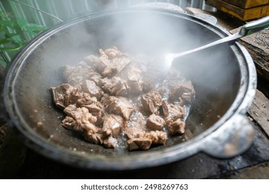 Traditional cooking method using a cauldron and fire. The aroma of smoke inherent in lamb meat. Perfectly fried for a delicious meal.