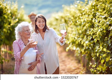 Traditional countryside vineyard. Smiling family on autumn vineyard tasting wine
 - Powered by Shutterstock