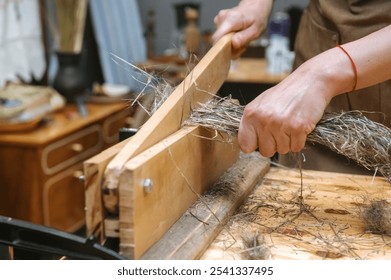 Traditional craftsmanship: fiber processing by hand for artisanal textile production. - Powered by Shutterstock