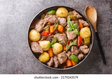 Traditional croatian dish Peka view, meat and vegetables in iron cover under warm glow close-up on the table. horizontal top view from above - Shutterstock ID 2179243579