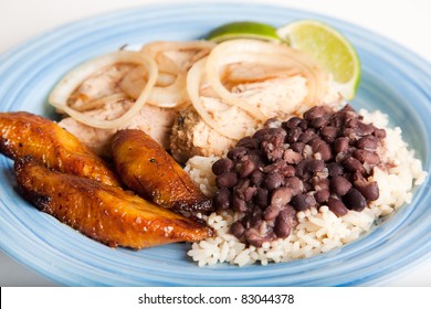 Traditional Cuban Meal, Of Roast Pork, Black Beans And Rice, And Sweet Fried Plantains.  Focus On The Beans And Rice, And The Plantains.