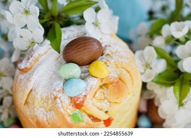 Traditional cupcake Easter cake kraffin with raisins on blue background. Cherry blossom, choco eggs. Close up of homemade cake. Cruffin with candied fruits. Food. Copy space. - Shutterstock ID 2254855639
