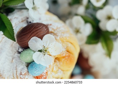 Traditional cupcake Easter cake kraffin with raisins on blue background. Cherry blossom, choco eggs. Close up of homemade cake. Cruffin with candied fruits. Food. Copy space. - Shutterstock ID 2254860733