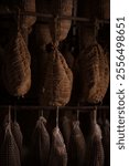 Traditional Curing Process for Artisanal Meats in Rustic Smokehouse