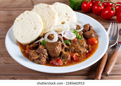 Traditional czech goulash with dumplings on wooden table - Shutterstock ID 2185662913