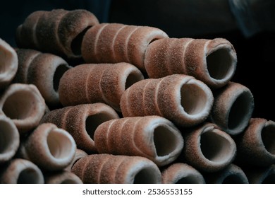 Traditional Czech trdelník pastries stacked for sale in a Prague market - Powered by Shutterstock