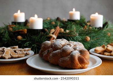 Traditional Czech and Slovak Christmas sweet plaited bread called vanocka (in Slovak vianocka), Christmas cookies and a Christmas advent wreath with four burning candles on wooden table. - Powered by Shutterstock