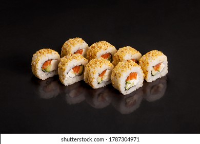 Traditional delicious fresh sushi roll set on a black background with reflection.  Sushi roll with rice, cream cheese, avocado, salmon, sesame. Philadelphia. Sushi menu. Japanese kitchen, restaurant.