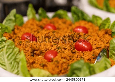 Traditional delicious Turkish foods bulgur salad, kisir. traditional side dish in Turkish cuisine. a plate or bowl of food with lettuce and tomatoes. turkish appetizer made of steamed cracked wheat.