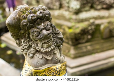 Traditional demon guards statue carved in stone in Bali island.