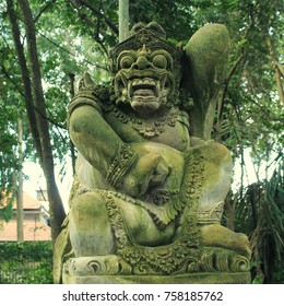 Traditional demon stone carved statue in Ubud, Bali island, Indonesia. Square toned image. Selective focus