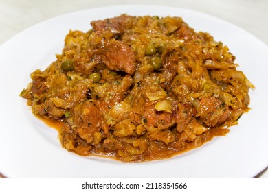 Traditional deutsch stew cabbage with meat, close up dish on the white plate - Shutterstock ID 2118354566