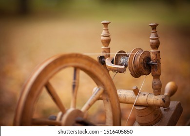 Traditional devices, vintage tailoring equipment concept. Old fashioned wooden distaff, spindle, spinning wheel.  - Powered by Shutterstock